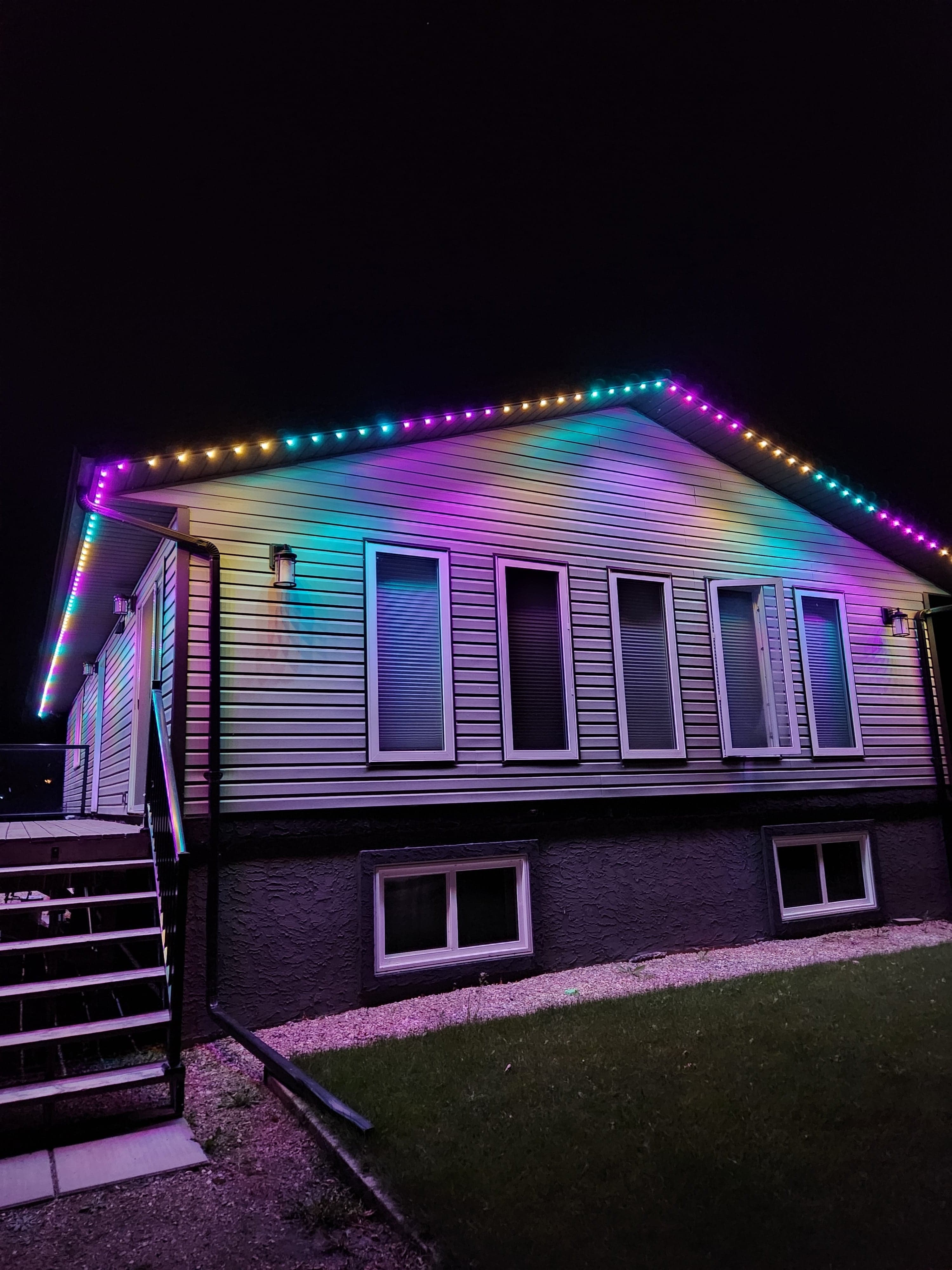 Same home with permanent LED lighting set to a full rainbow gradient showing all available colors